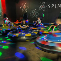 Kids spinning in neon-lit bumper cars at The Fun Lab in Blaine, MN.
