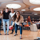 Couple playfully bowling together at King’s Entertainment