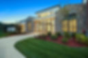 Exterior view of Bedford Event Center in Bedford, NH, showcasing stone facade, modern windows, and landscaped entrance for weddings and events