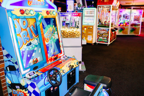 Brightly lit arcade basketball game and claw machines
