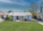 Exterior photo of home with green grass replacement.