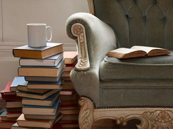 books beside an arm chair