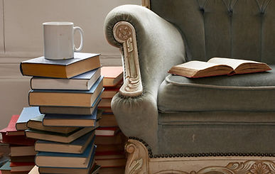 Pile of books with coffee cup on top