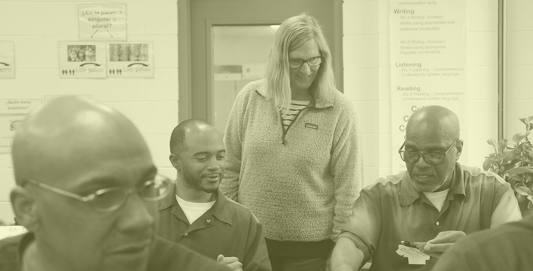 Photo of two students and a teacher in the classroom