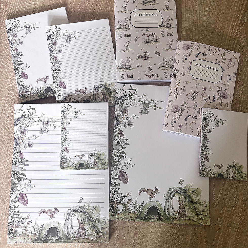 Personalised woodland stationery gift set featuring lined notepads, notebooks, and writing paper with watercolour illustratio