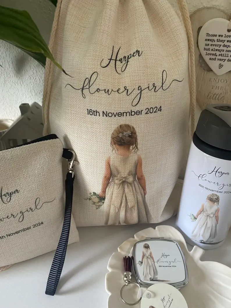 Thumbnail: view of the personalised flower girl gift hamper showcasing a canvas pouch, drawstring bag, custom water bottle, and a compac