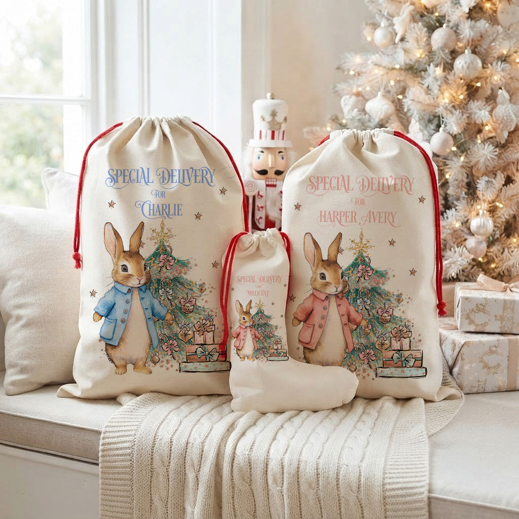 A Personalised Christmas Bunny Santa Sack displayed alongside matching holiday stockings and sacks near a decorated Christmas