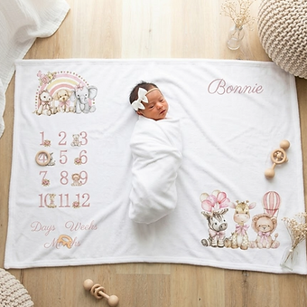 Personalised baby milestone blanket featuring watercolor safari animals, a rainbow, monthly tracking numbers from 1 to 12, an