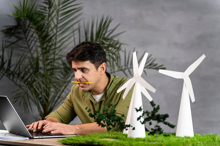 man-working-eco-friendly-wind-power-project-with-wind-turbines-laptop (1).jpg