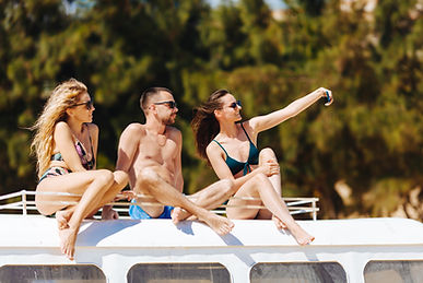 travelers-taking-selfie-while-sitting-top-retro-bus.jpg