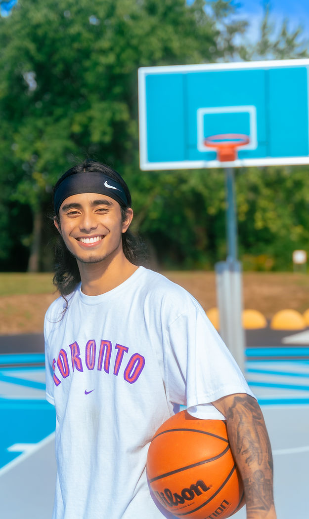 Riq B smiling on basketball court