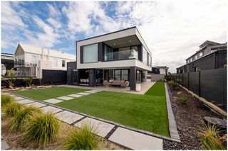 Architecture photograph of a modern angular home with landscaping