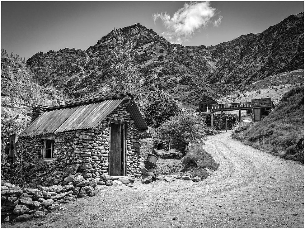 Stone huts and abandoned buildings at an abandoned gold mine in the hills of Central Otago, New Zealand