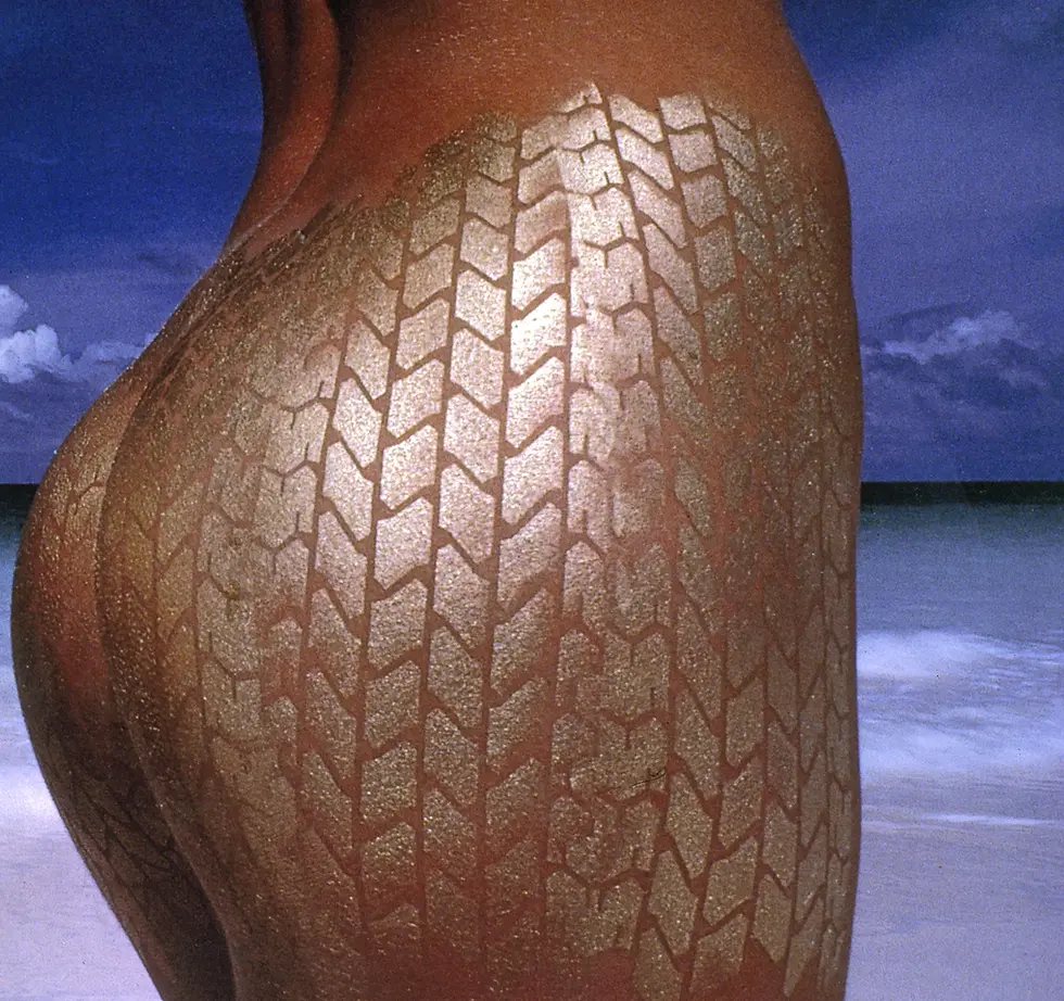 Thumbnail: Detail of golden P6 tire tread body paint texture, skin tones, and archival pigment print quality by Uwe Ommer