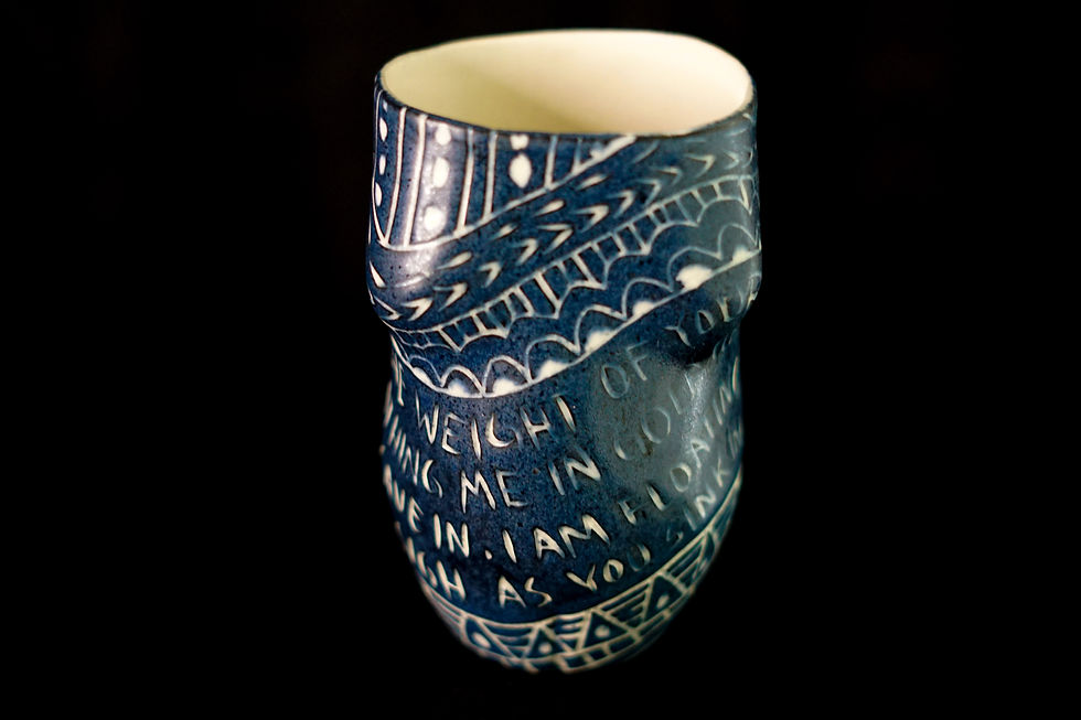 Thumbnail: Close-up of sgraffito ceramic engraving highlighting wave motifs, geometric triangles, and crisp white script text.