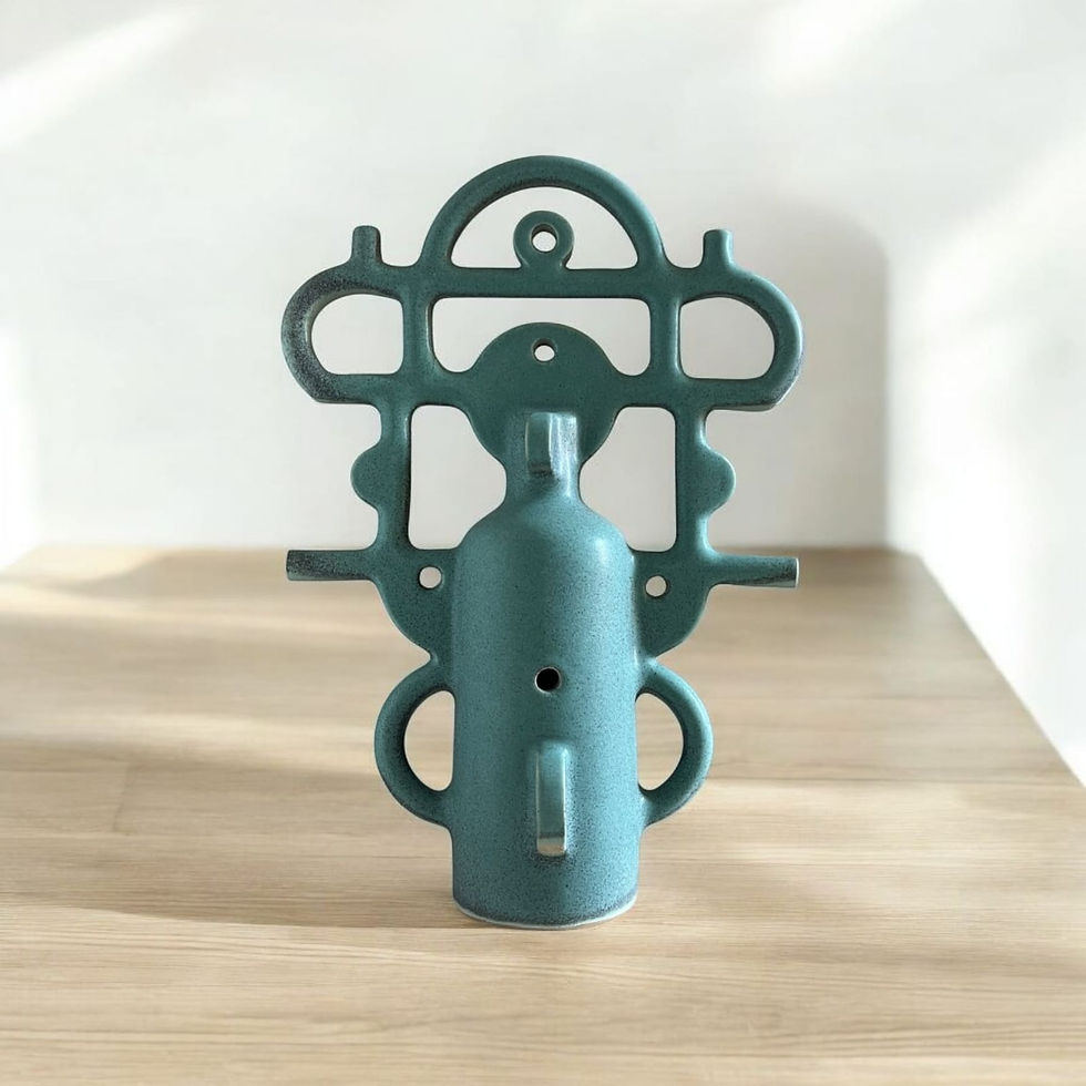 Thumbnail: Close-up of matte turquoise glazed stoneware highlighting hand-molded joints, small punctures, and negative space.