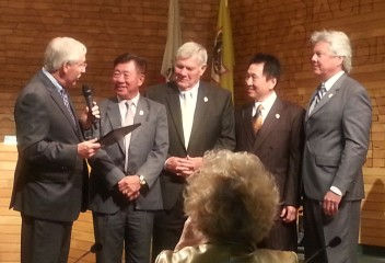 Incoming Mayor Gary Kovacic (l) honors outgoing Mayor John Wuo, standing next to new Mayor Pro Tem Roger Chandler (center) and Council Members Sho Tay and Tom Beck