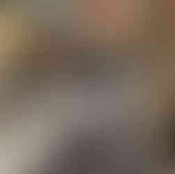 Young girl walks down a narrow cobblestone street with bright coloured streamers hung above