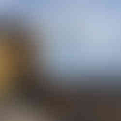 Yellow castle against cloudy blue sky