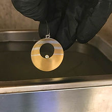 A Pendant being placed into an Ultrasonic Cleaner