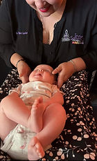 Dr. Taylor adjusts a baby