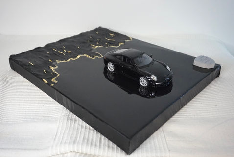 Porsche 911 in black with black lava and gold edging 