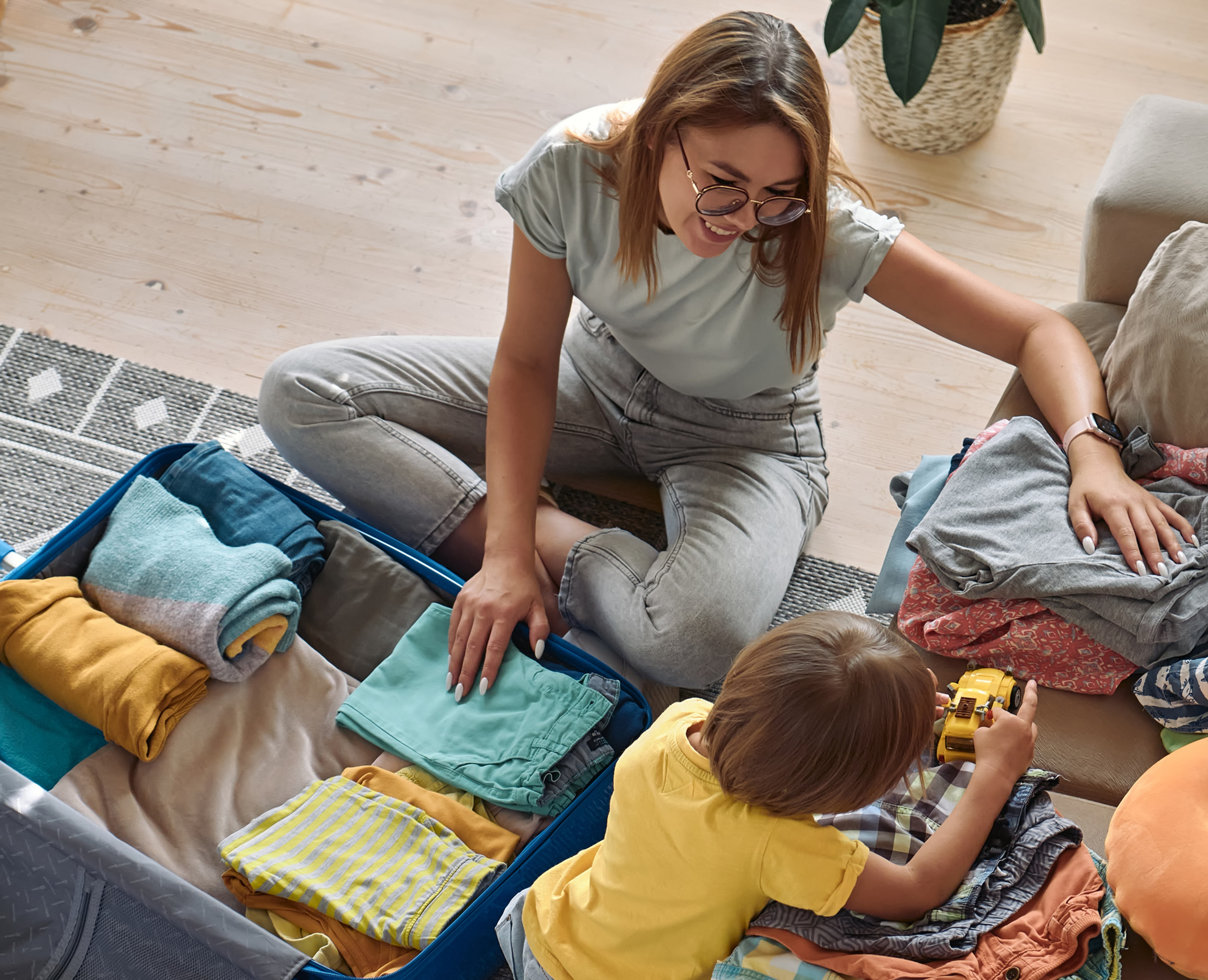 mom and child packing a suit case