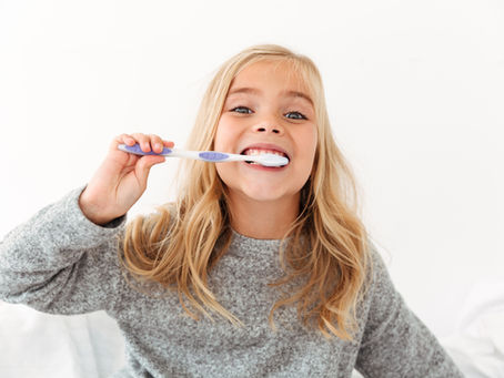 little girl with toothbrush