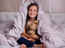 little girl under covers