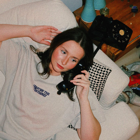 Woman in 'Before the Internet' t-shirt on a rotary phone.