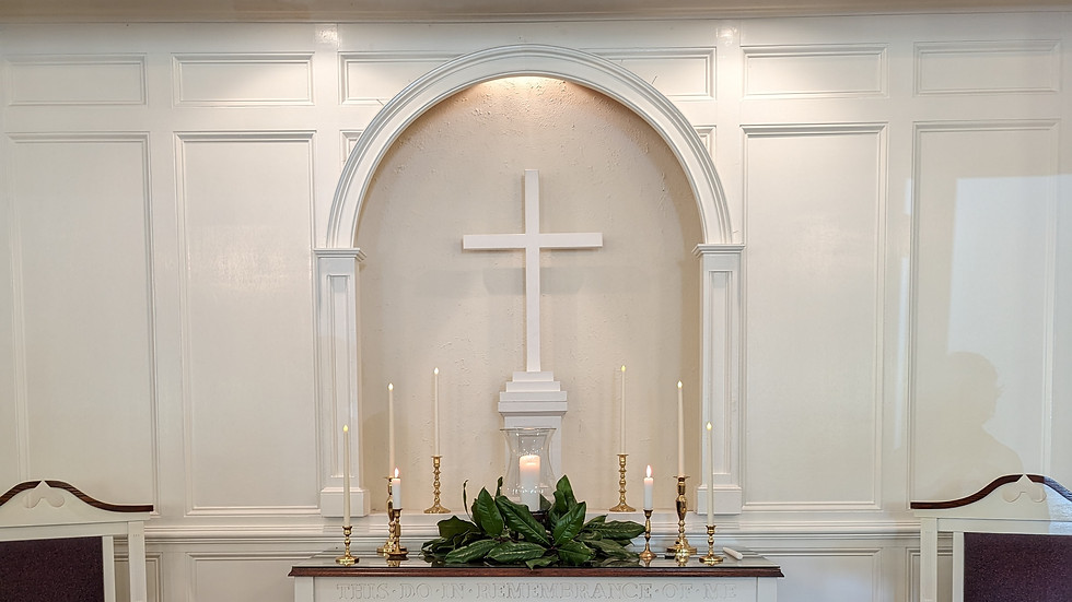 White altar with a cross at a church in Woodbury GA