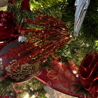 Glittery red floral pick on a Christmas tree