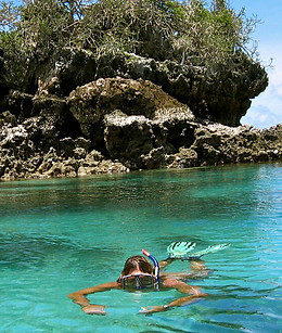 snorkeling in bright blue ocean waters in Tanzania