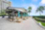 Beachfront clubhouse with outdoor seating and ocean views at Sea Ranch Club Lauderdale-by-the-Sea