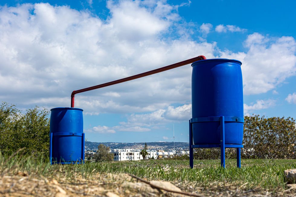 ECO ART - AQUA MEMORIA Rinos Stefani, Sacred Hydraulics - Communicating Vessels, 2025. Plastic barrels, plastic pipes, metal bases, 1.35 x 4m x 70cm / Ρήνος Στεφανή, Ιερά Υδραυλικά - Συγκοινωνούντα δοχεία, 2025. Πλαστικά βαρέλια, πλαστικές σωλήνες, µεταλλικές βάσεις 1.35 x 4m x 70cm