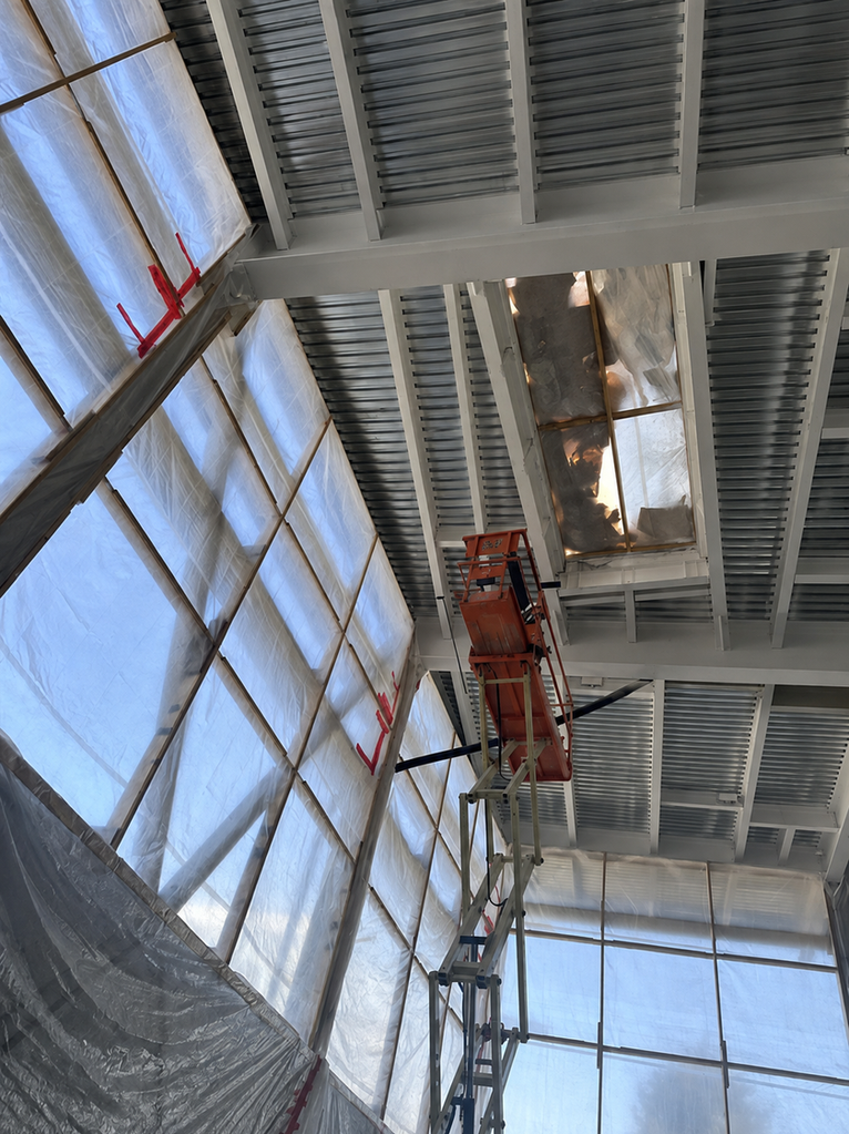 Work in progress structural steel fireproofing with lift equipment and coated beams