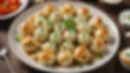 High angle view of a plate of pelmeni served with sour cream