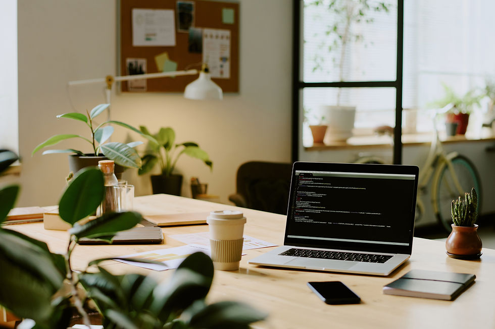 No people shot of laptop with code on screen, cup of coffee and smartphone on desk in mode