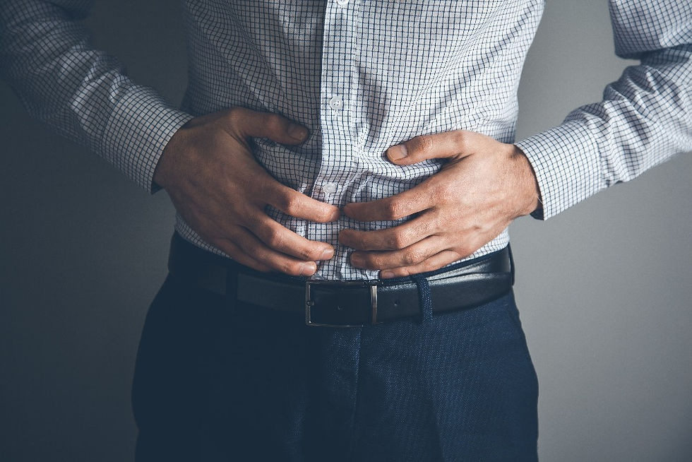 man clutching his abdomen in pain