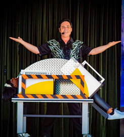 Magician performing a trick for the front row audience