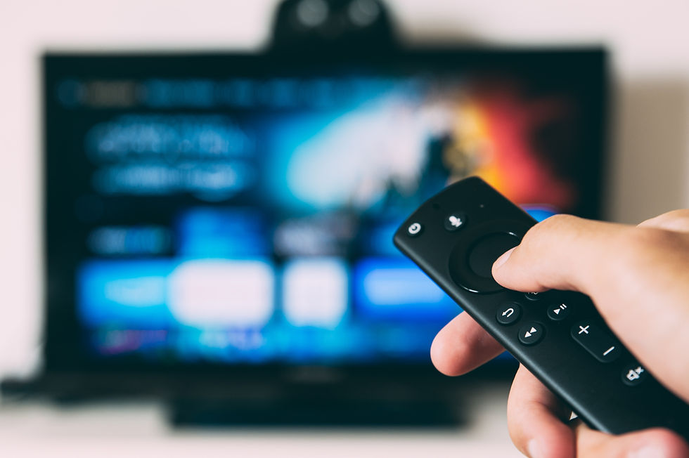 A person holding a remote using a streaming service