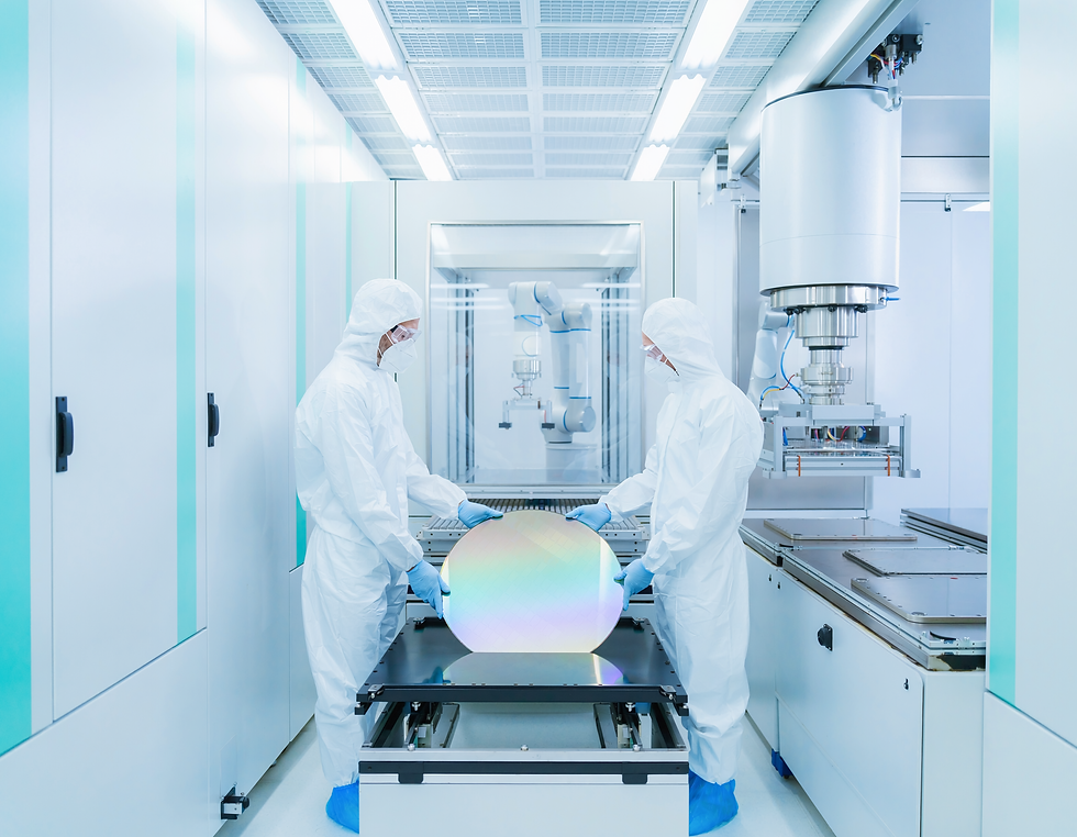 Semiconductor engineers inspecting an advanced silicon wafer inside a cleanroom