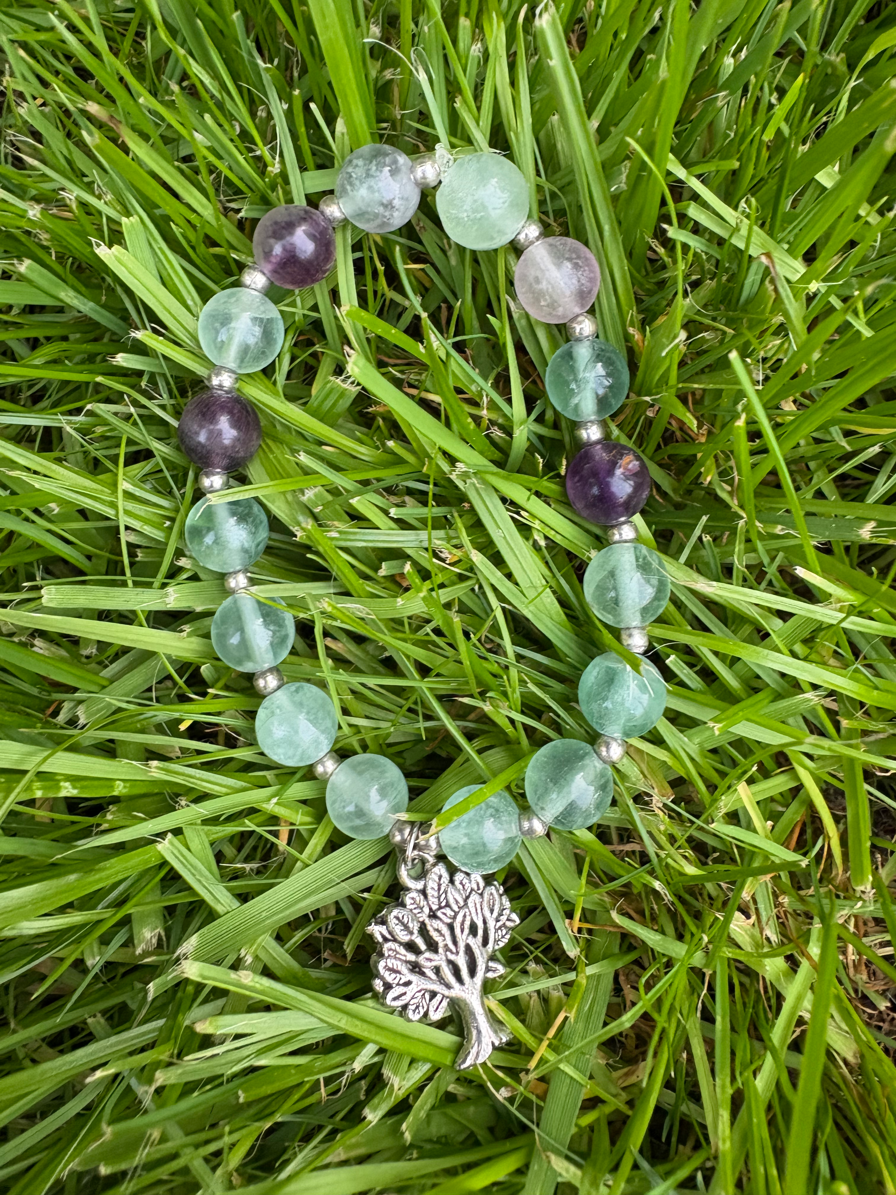 Fluorite bracelet with silvertone tree charm and spacer beads. 16cm in size. Light green and purple tones.
