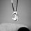 Thumbnail: THYRA hagstone silver pendant hanging infrount of natural stones.