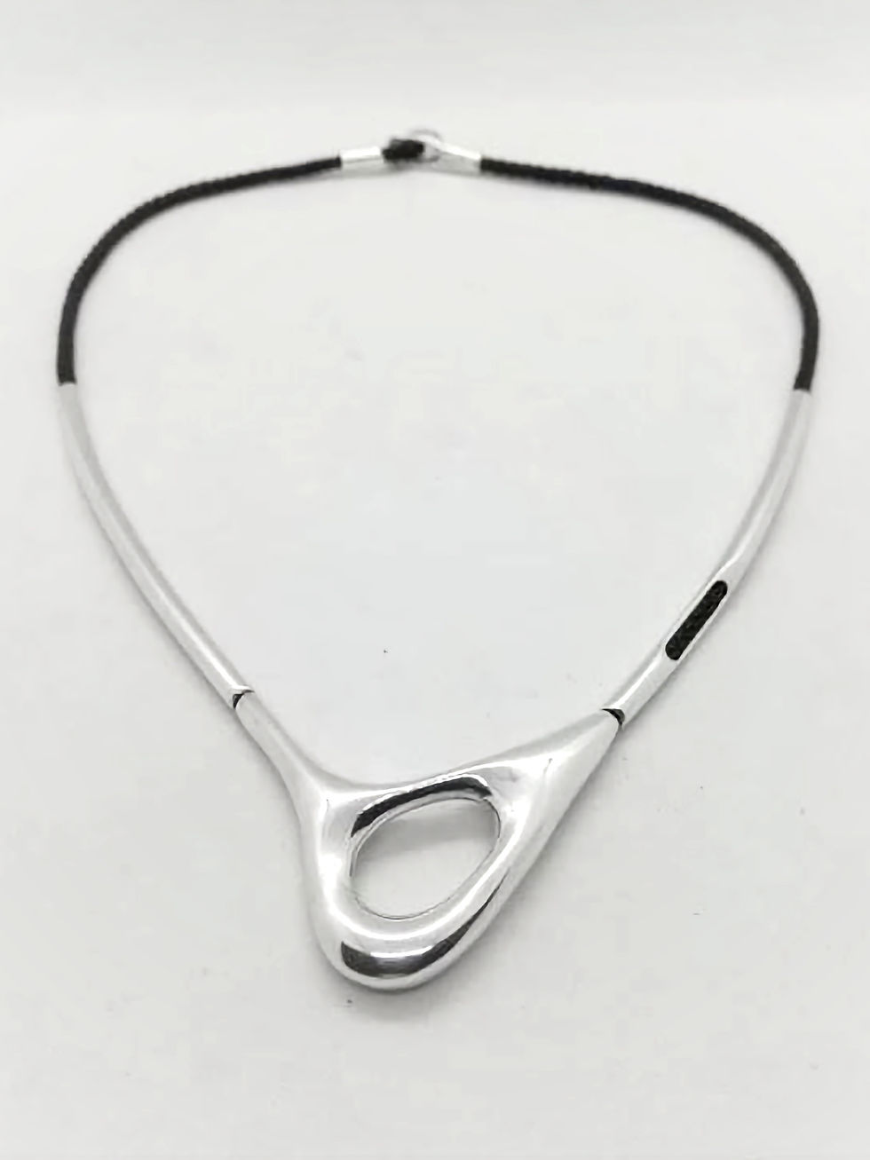 Thumbnail: PORTAL choker in sculptural silver with centre hollow form and black cord.