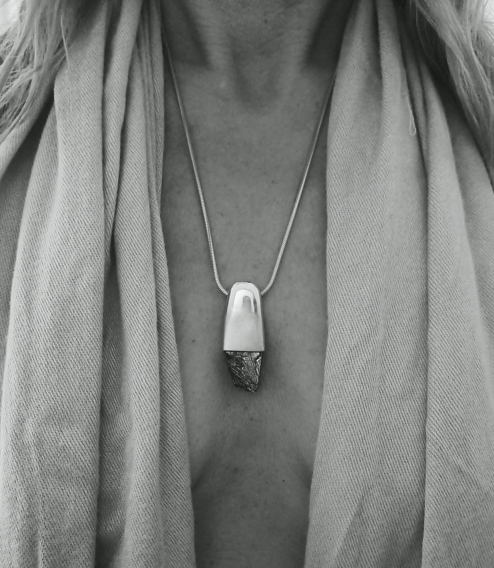 Model wearing a bold pendant featuring raw Galena in a sculptural pure silver setting on a snake chain.