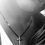 Thumbnail: Aman wearing the ssculptural silver cross pendant on black cord necklace.