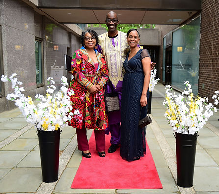 2023 Paul Robeson 125th Gala in Philadelphia, Pa with UCP board members posed on a red carpet with floral decorations; event setting.