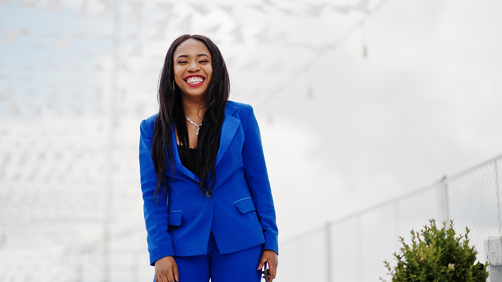 a smiling black woman in a blue suit
