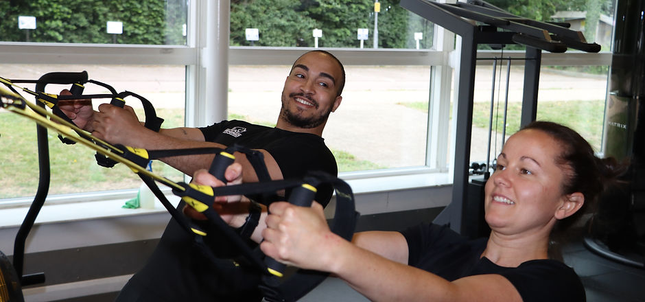 Personal training session using TRX for a back exercise
